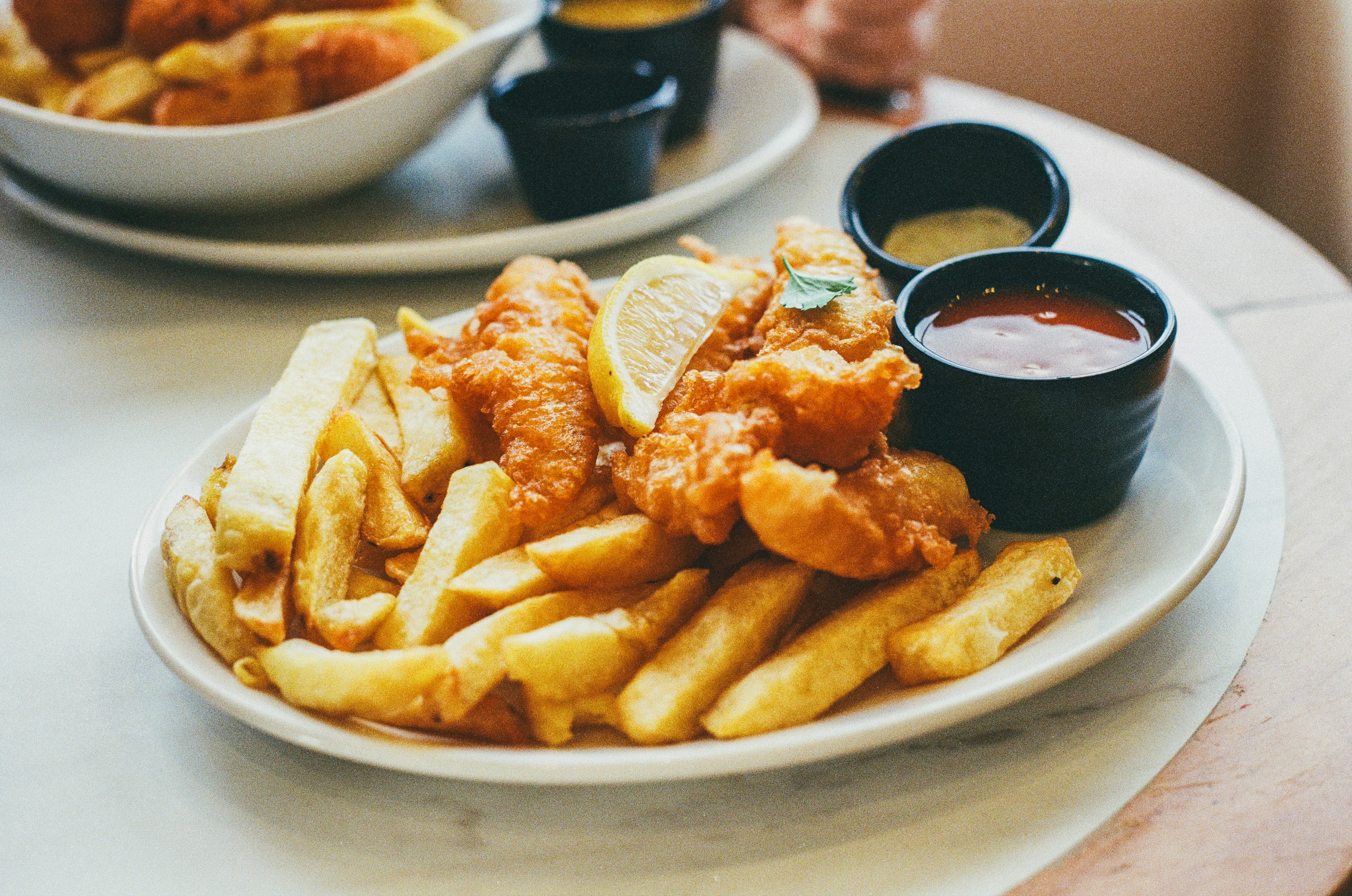 Golden battered cod with crispy chips and lemon.