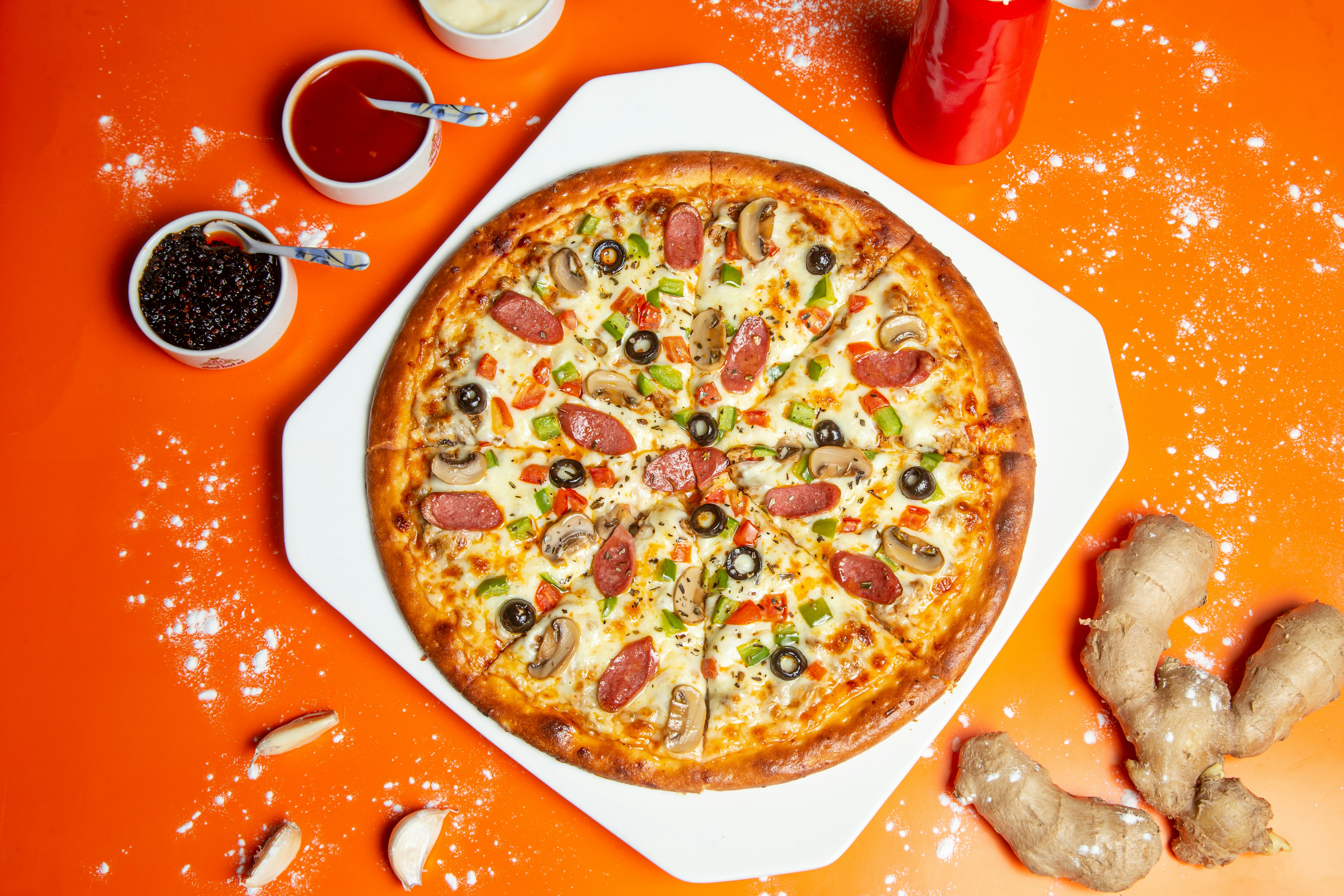 Stone-fired pizza topped with basil leaves and melted cheese.